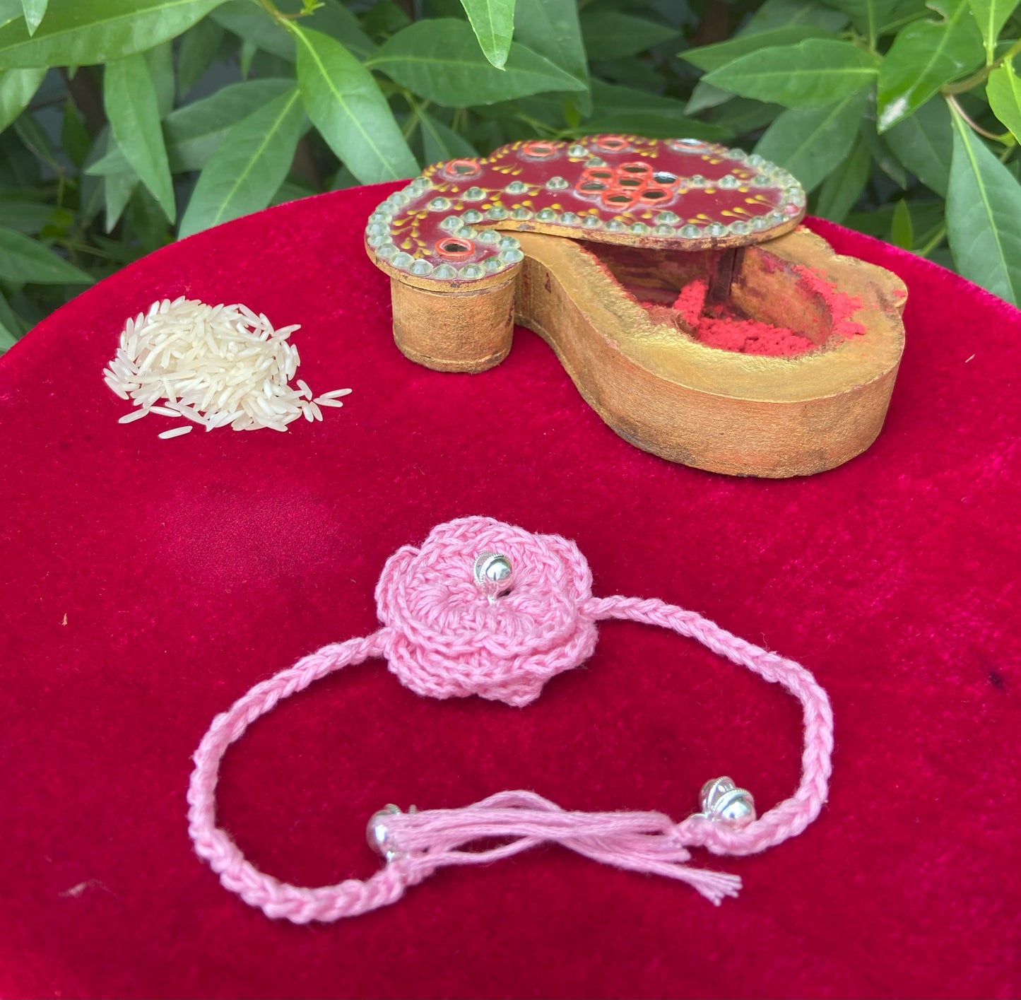 "Blush Bloom Rakhi – Crochet Elegance with Silver Stone & Pink Petals"