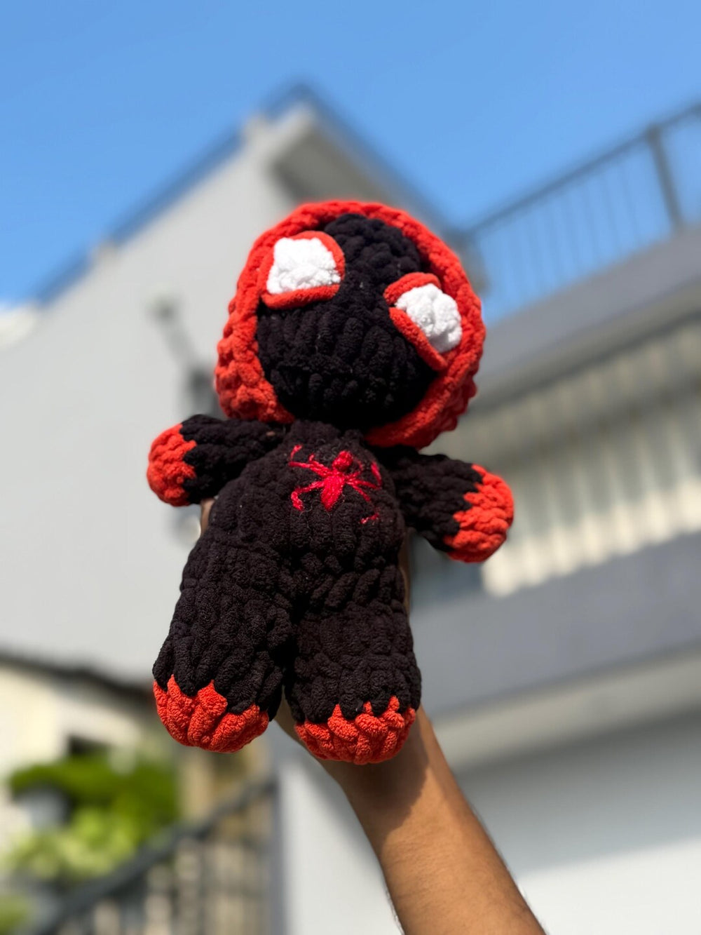 Black and red crochet superhero plush