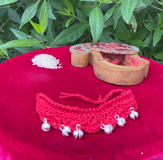 "Rhythm of Tradition – Red Crochet Rakhi with Silver Ghungroo Charm"
